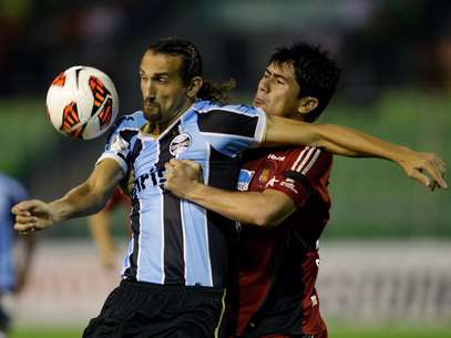 Barcos protege bola da presença de Sanchez; Grêmio fez segundo tempo ruim e levou a virada do Caracas Foto: AP