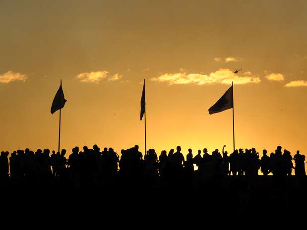 Manifestantes se reúnem ao por do sol antes do início dos protestos na Esplanada dos Ministérios, em Brasília Foto: AFP