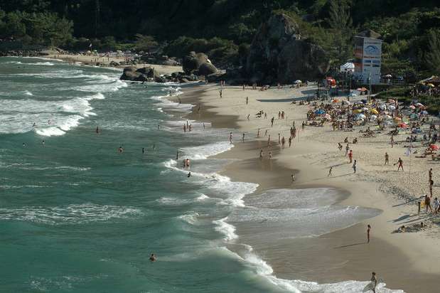 Prainha, RJ - Praia tradicional do Rio de Janeiro situada na Barra da Tijuca, Prainha é uma das preferidas dos surfistas da cidade e se destaca por sua beleza, com 700 metros de areia protegidos por morros cobertos de vegetação. Corpos sarados relaxam na praia, degustando sanduíches naturais, sucos e açaí nos quiosques Foto: Visit Brasil