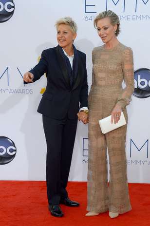 Ellen DeGeneres apostou em um conjunto de calça e paletó com lapela acetinada assinada por valentino. Ela chegou acompanhada de Portia de Rossi, que dividiu opiniões em seu macacão nude Foto: Getty Images